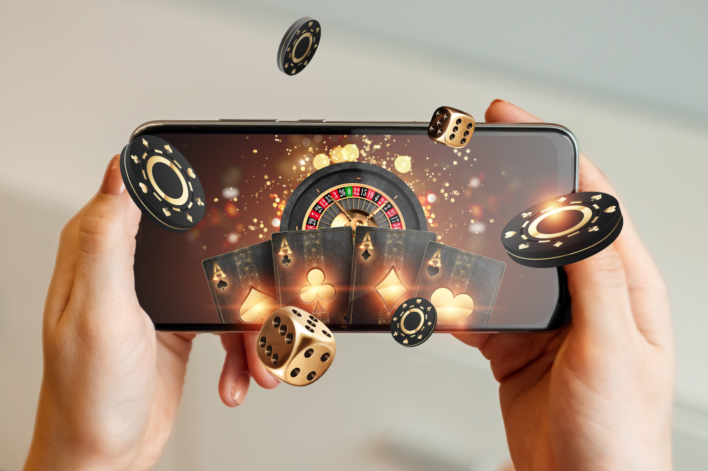 Playing cards, casino chips, roulette and dice on a smartphone screen